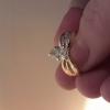 11/4 pear shaped diamond ring with 4 smaller diamonds on each side. 