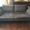 A 6 months old, grey sofa with ottoman in great conditon