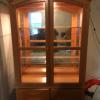 Lighted blond china cabinet