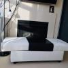 Black and White Italian Leather Ottoman with storage space in the centre.