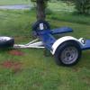 Pull behind vehicle tow dolly