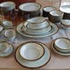 Noritake 12 piece place setting.  Number 5675 Goldkin.  24 carat gold with black back ground. offer Home and Furnitures