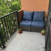 Brown Patio Love Seat With Blue Cushions